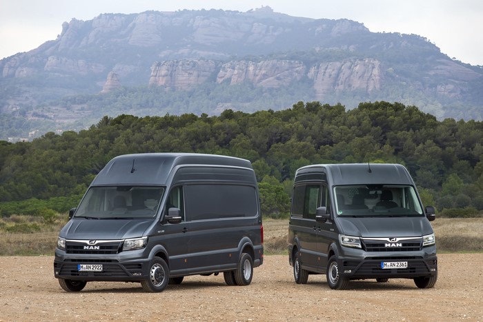 Two MAN TGE vans in a landscape