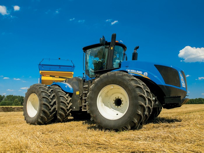 Blue New Holland T9.700 tractor with a seeder