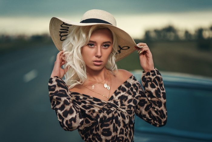 Woman in a leopard print dress and hat