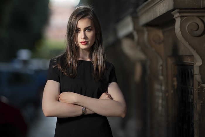 Woman with brown hair in a black dress