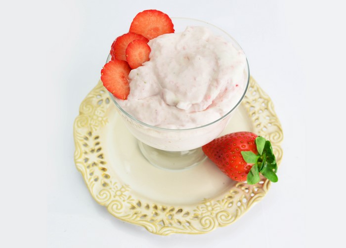 Strawberry ice cream with fresh strawberries on a plate