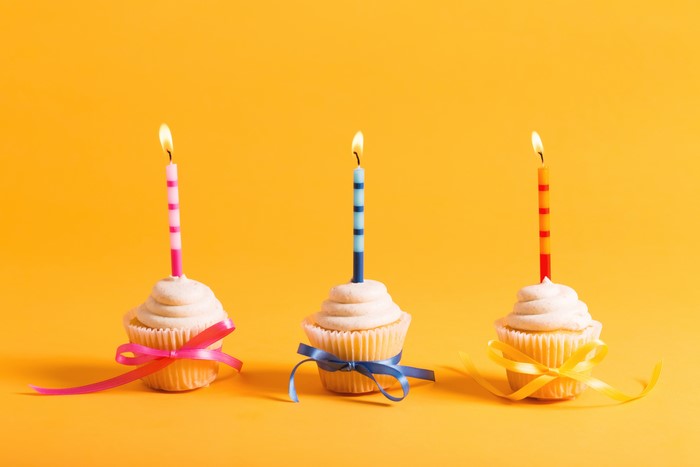 Three cupcakes with candles and bows