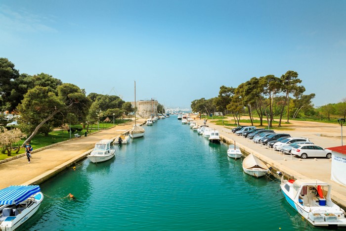 Canal with boats and cars in Trogir, Croatia