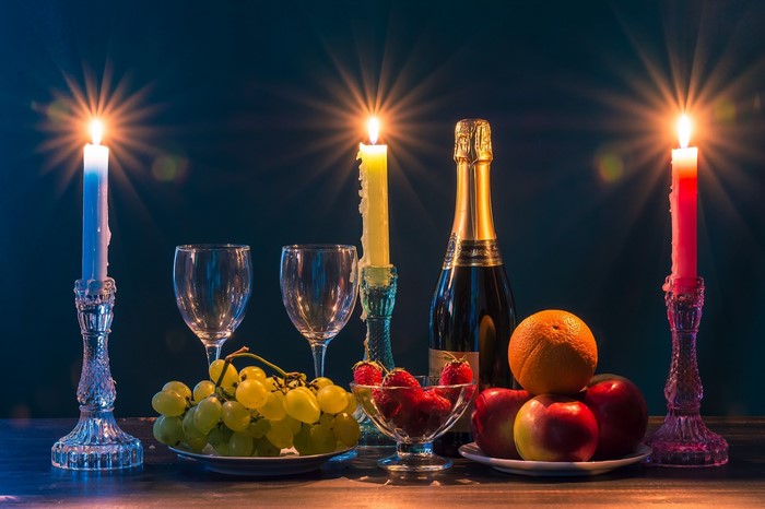 Candles, Champagne, and Fruit Still Life
