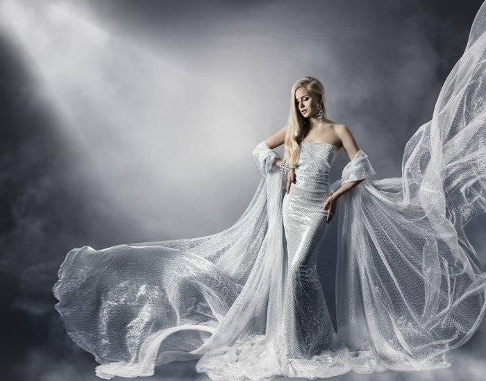 Woman in a sparkling silver dress with a flowing train