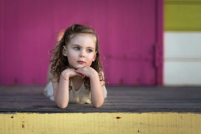Young girl with blue eyes lying down