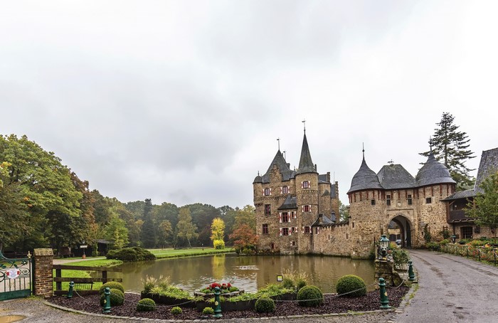 Burg Satzvey castle with pond and trees in Germany