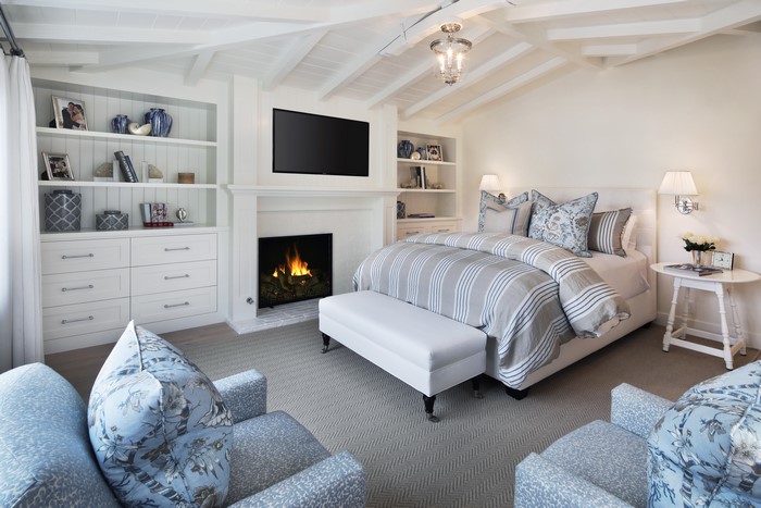 Bedroom with fireplace and built-in shelves
