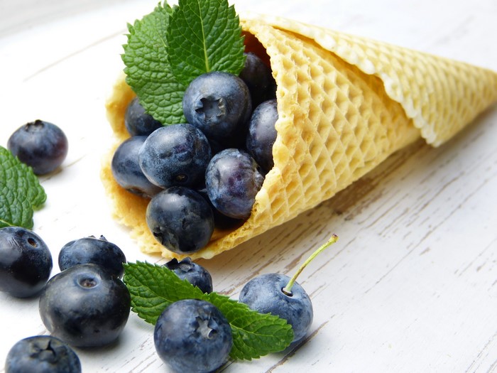 Blueberries and mint leaves in a waffle cone