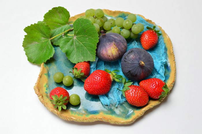 Strawberries, Grapes, Figs, and Leaves on a Plate