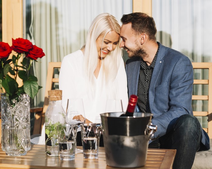 Couple enjoying drinks with roses