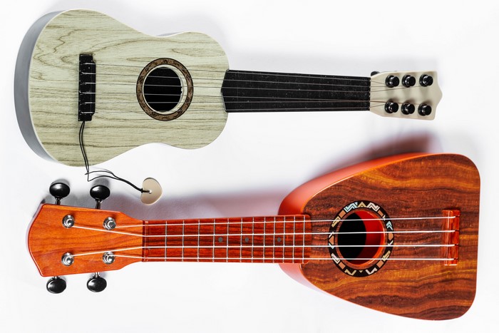 Two ukuleles on a white background