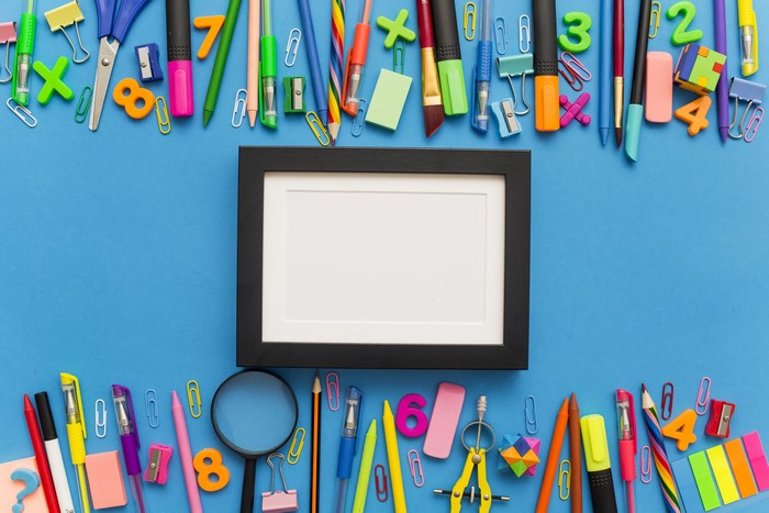 School supplies and a picture frame on a blue background