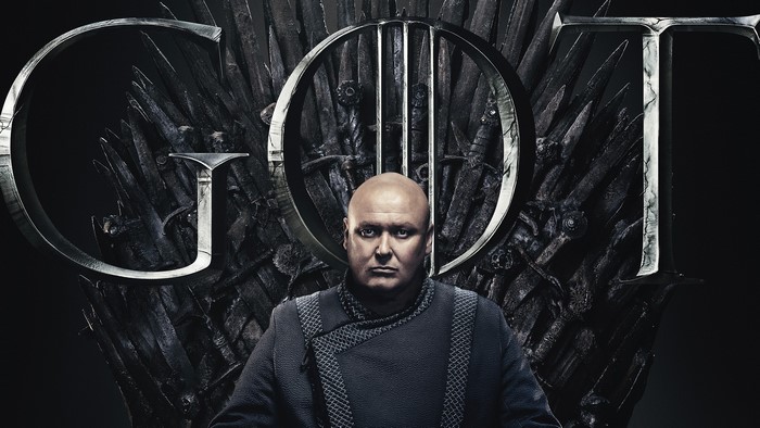 Lord Varys from Game of Thrones on the Iron Throne