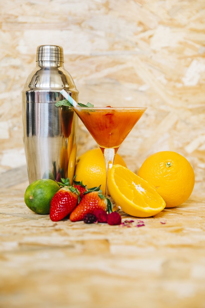 Cocktail shaker with cocktail and fruits