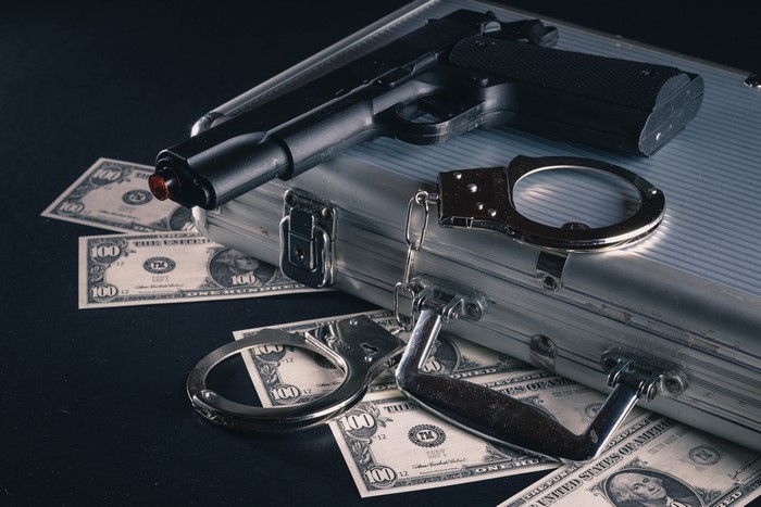 Pistol, Handcuffs, Money, and Suitcase