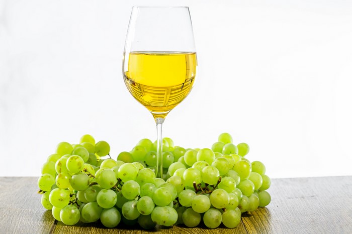 White Wine in a Glass with Green Grapes