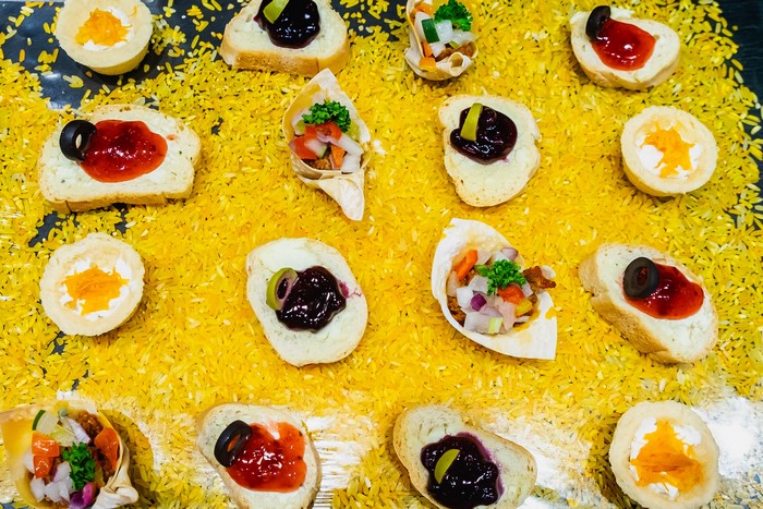 Assortment of canapés and appetizers on yellow rice