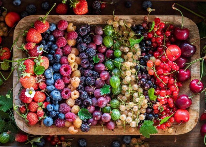 Assortment of Fresh Berries and Cherries on a Wooden Platter
