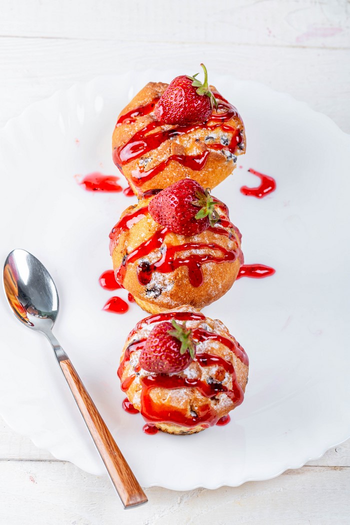 Three Strawberry Muffins with Jam and Spoon
