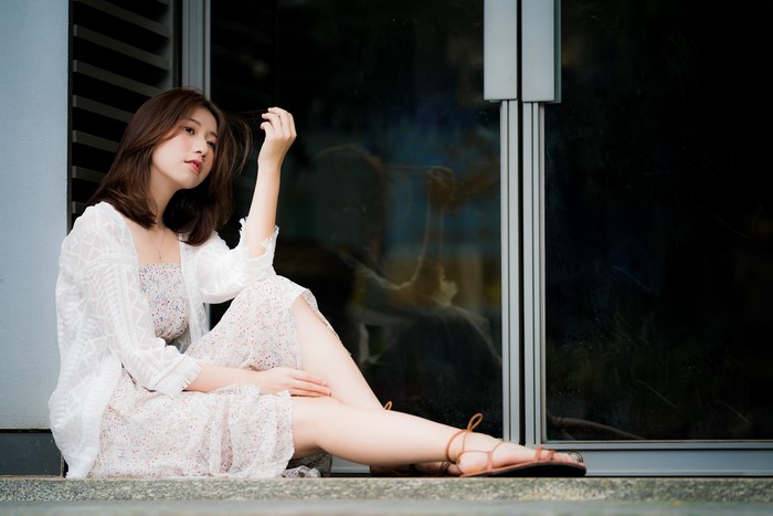 Asian woman sitting by a window