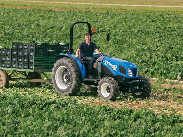 New Holland TD3.50 tractor pulling a trailer of crates