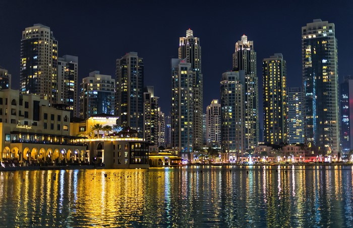 Dubai skyline at night with water reflections
