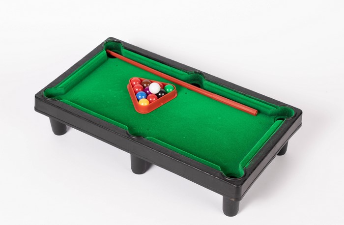 Miniature billiard table with balls and cue