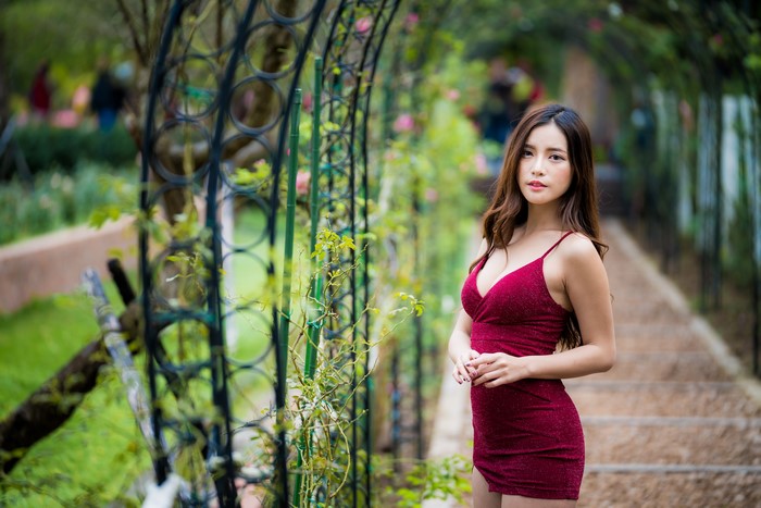 Asian woman in red dress in garden
