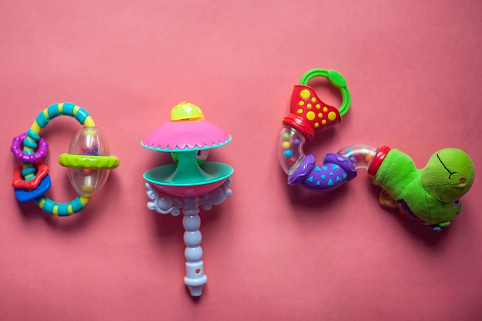 Baby rattles on a pink background