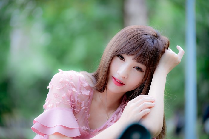 Asian girl with brown hair in pink dress