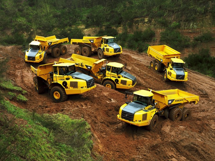 Yellow Volvo Articulated Haulers on Muddy Terrain