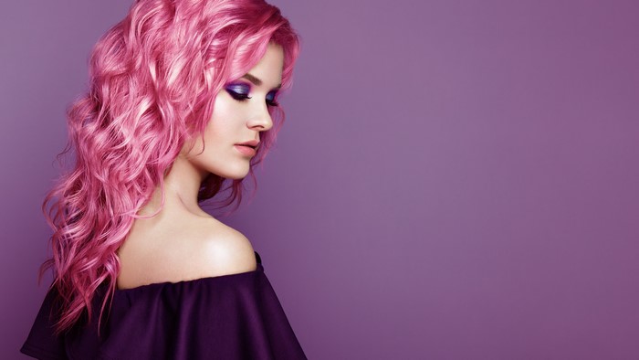 Woman with pink hair and purple makeup