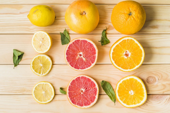 Lemons, Orange Fruit, and Grapefruit Slices on Wood Planks