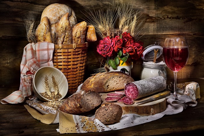 Still-life with bread, sausage, wine, and roses