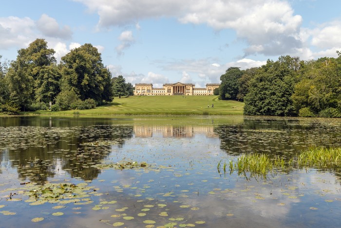 Stately home reflected in Octagon Lake, England