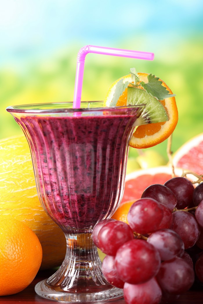 Purple smoothie with fruit garnish and grapes