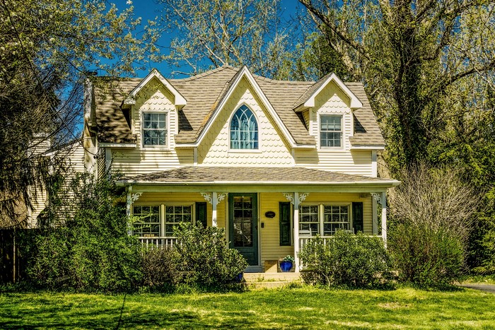 Yellow house with dormer windows and porch in New Jersey, USA