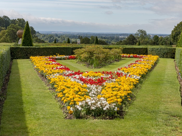 Cliveden Garden, England with flower beds and manicured hedges