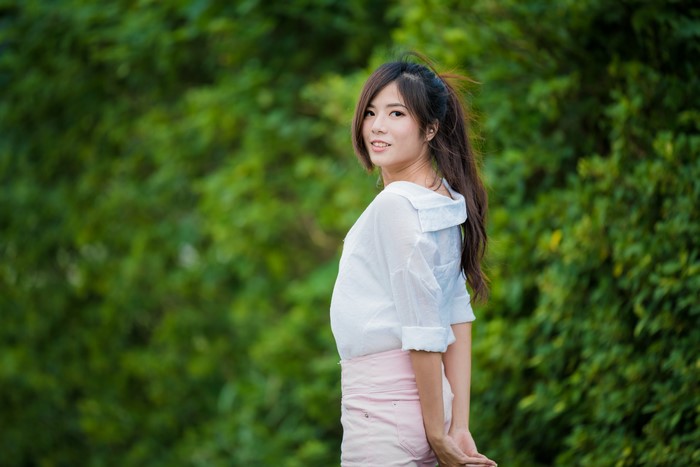 Asian woman in white shirt and pink shorts
