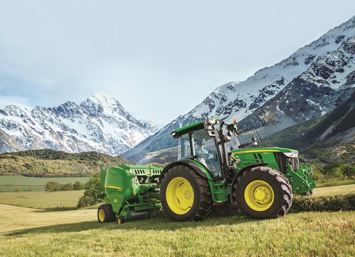 John Deere 5125R Tractor with Baler in Mountains