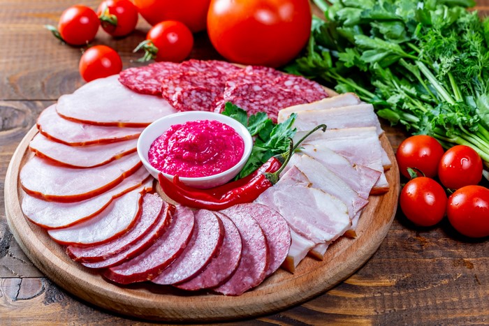 Sausage, Ham, and Bacon Platter with Tomatoes and Dip