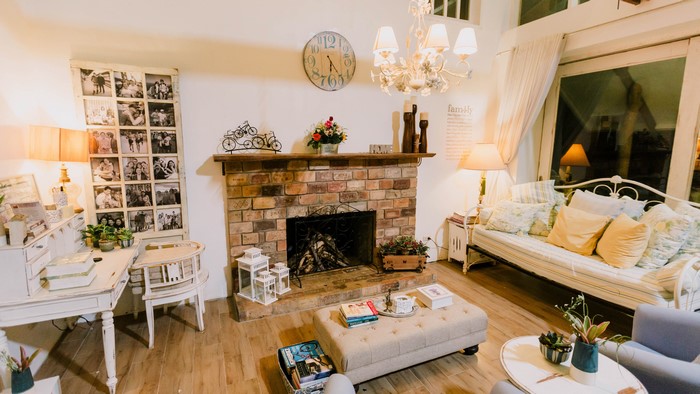 Living room with fireplace, sofa, and chandelier