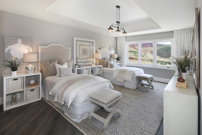 Bedroom with two beds and a chandelier