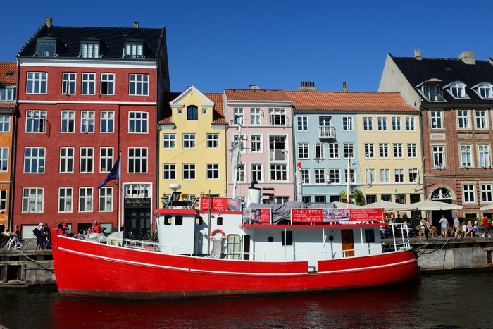 Colorful buildings and a red boat in Copenhagen, Denmark