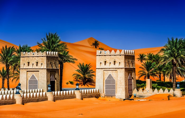 Desert Oasis with Arabic Architecture and Palm Trees