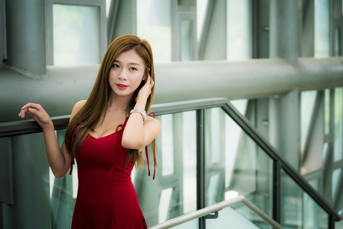 Asian woman in red dress posing