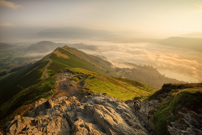 Mountain ridge at sunrise with fog in Cumbria, England