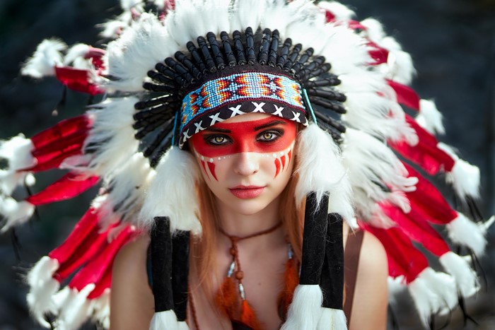 Woman with Native American headdress and face paint