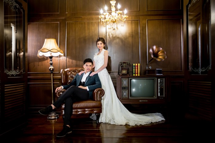 Asian Couple in Vintage Room with Armchair and Lamp